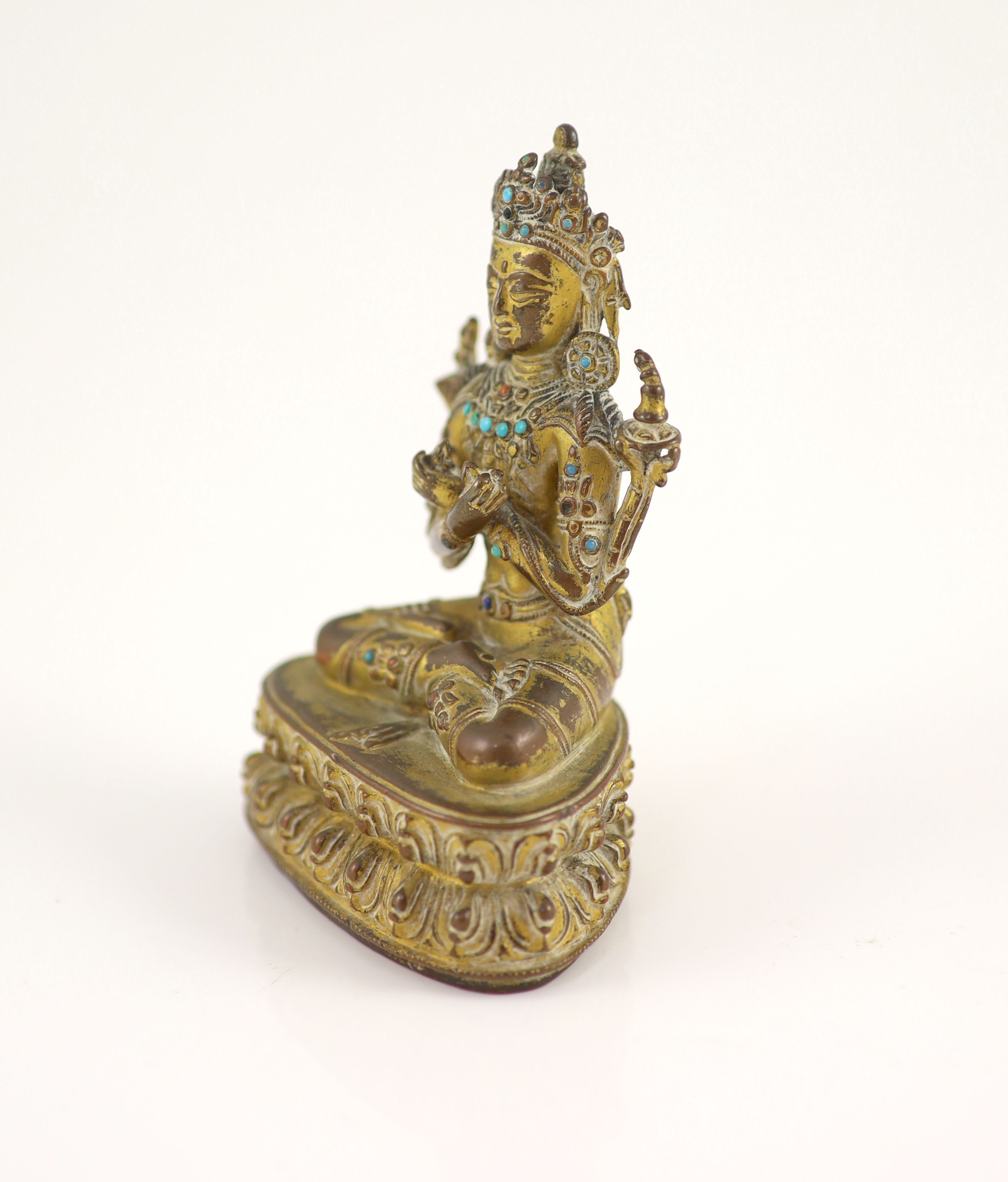 A Tibetan gilt copper alloy seated figure of Maitreya, possibly 15th century, 11.5 cm high